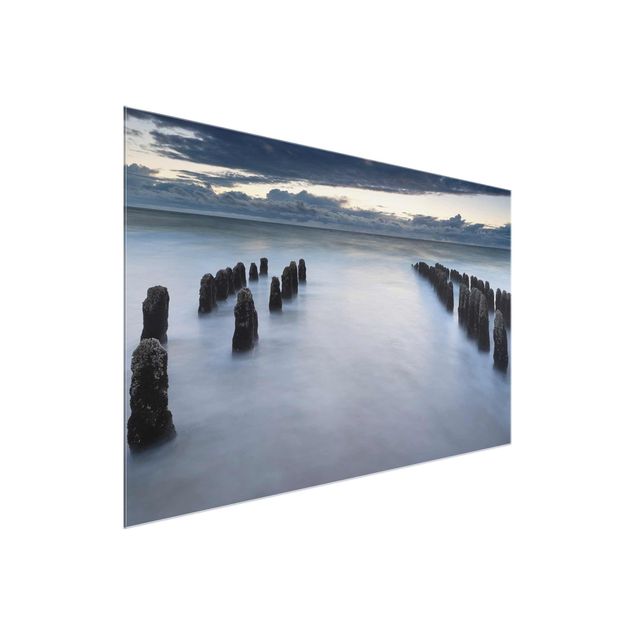 Glass prints landscape Old Wooden Posts In The North Sea On Sylt