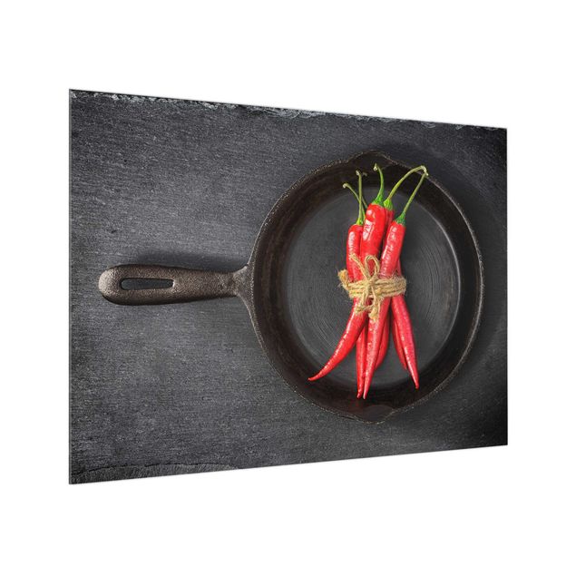 Glass art splashbacks Bundle Of Red Chillies In Frying Pan On Slate